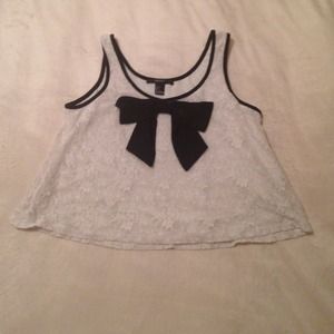 Cropped lace tank top with black bow.