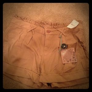 Bundle of tan cotton sorts and dress shorts.