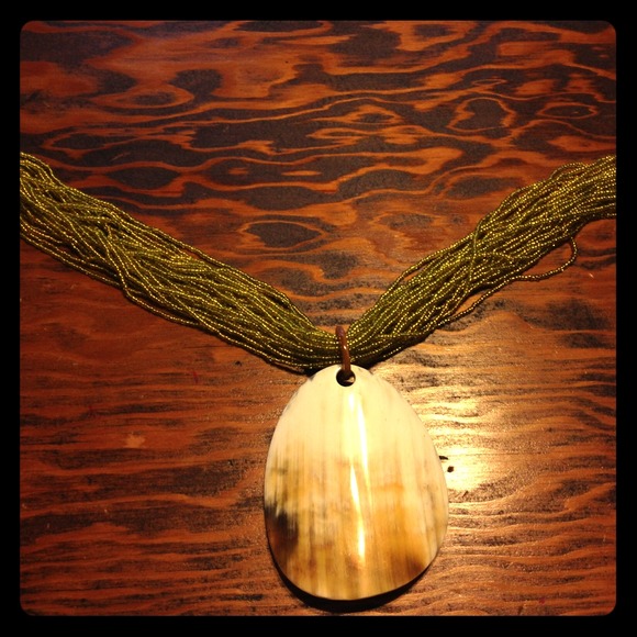 Hand strung beaded necklace w/ cow horn medallion