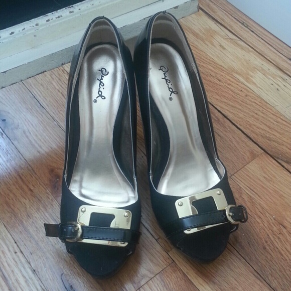 Sold.  Black and gold platform pumps
