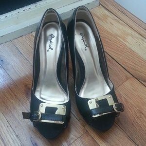 Sold.  Black and gold platform pumps