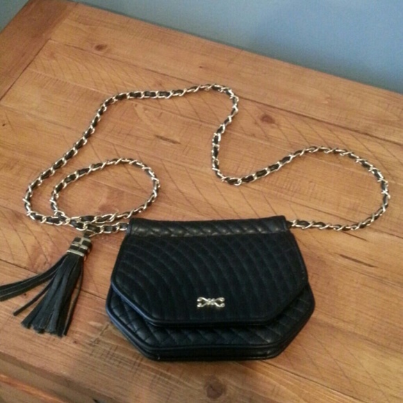 Black leather clutch with black and gold strap