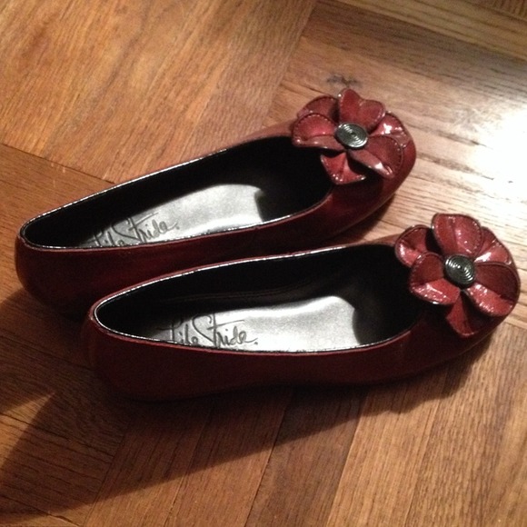 Red flower-adorned flats.