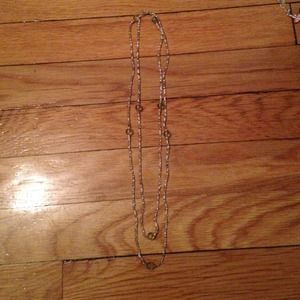 One long pale green and white beaded necklace