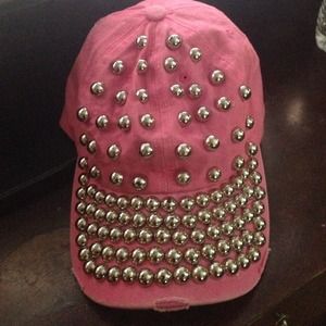 A pink hat with silver studs