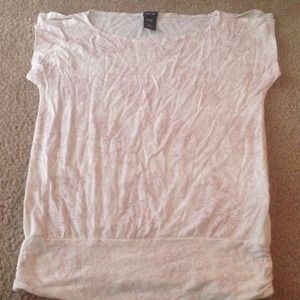 Cream shirt with pink flower designs.