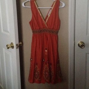 Orange dress with embroidered flowers.