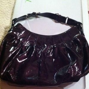 A dark plum shoulder purse that's patent leather