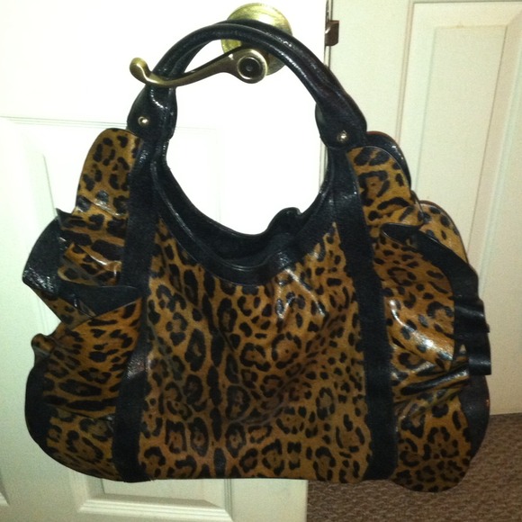 A leopard print purse with cute ruffles on sides