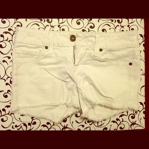GUESS white jean shorts.
