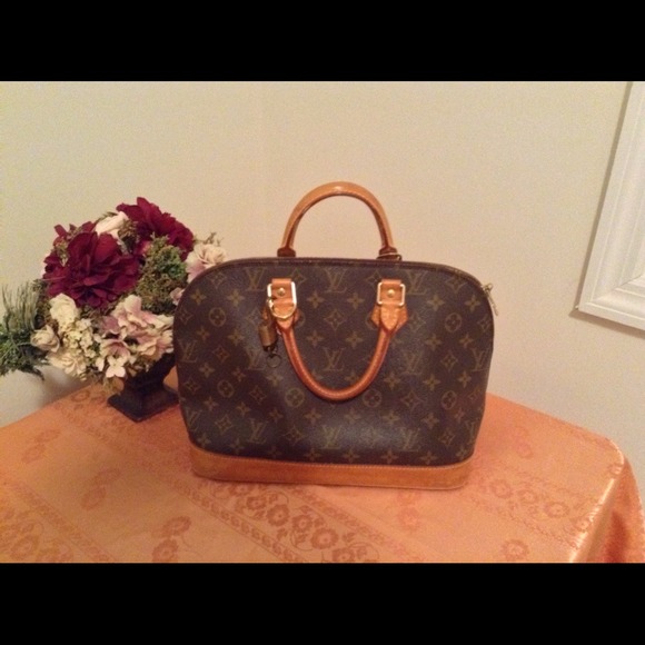 Sold..Authentic LV alma with lock, key and dustbag