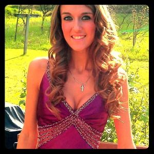An elegant long purple dress with crystal accents.