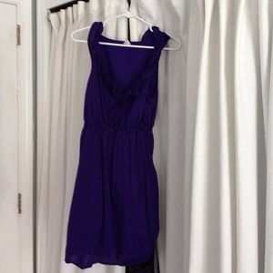 Sleeveless dress with ruffled neckline.