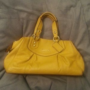 Small mustard yellow Coach purse