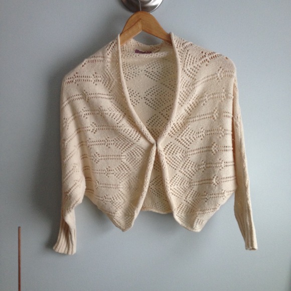 Cream cardigan with single button closure