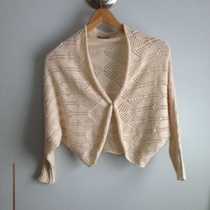 Cream cardigan with single button closure