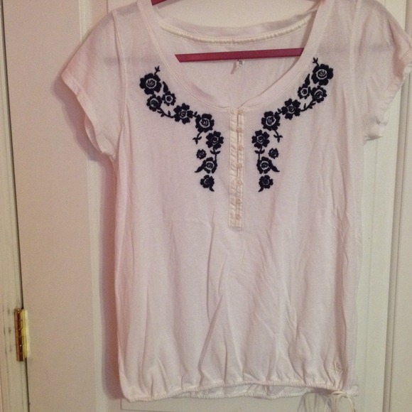 White shirt with blue flowers along neck