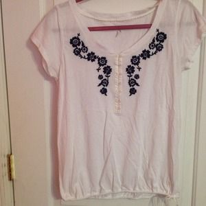 White shirt with blue flowers along neck