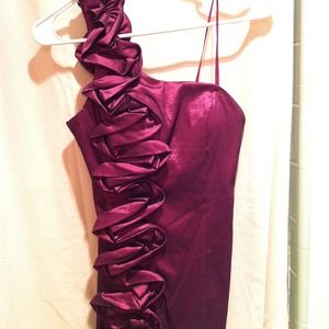 One shoulder wine colored dress.