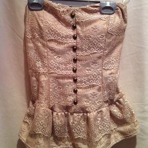 Strapless tan top with button detailing.