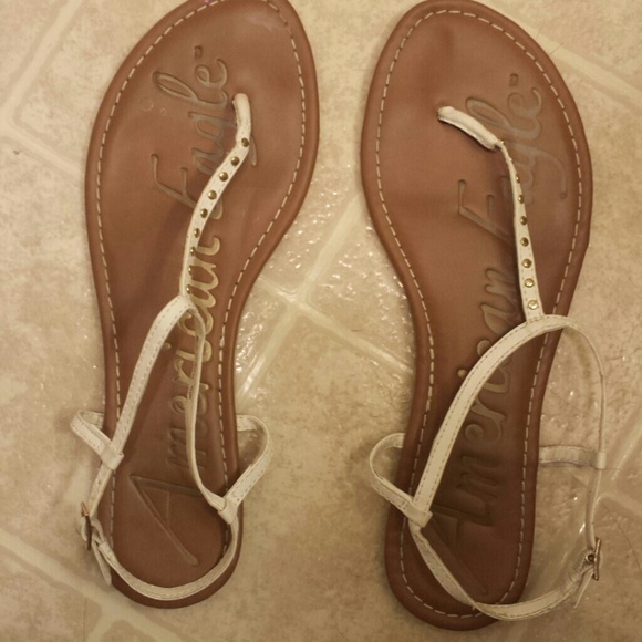 White sandals with small gold dots