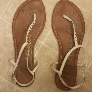 White sandals with small gold dots