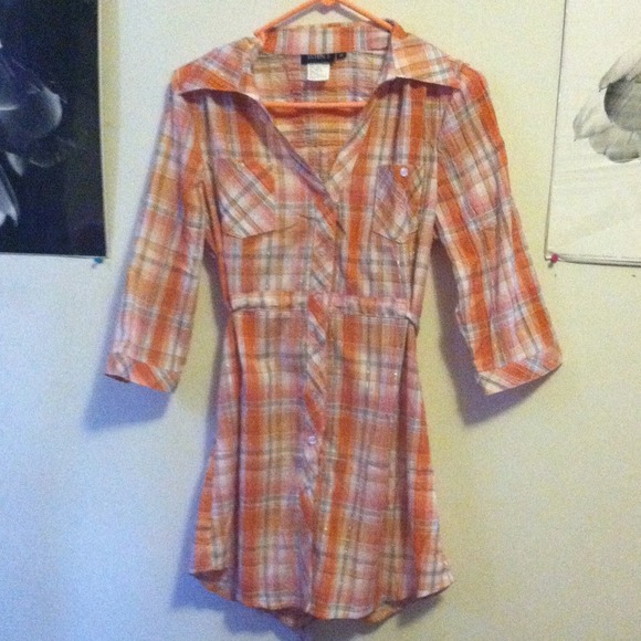 Long plaid shirt with tie at the back.