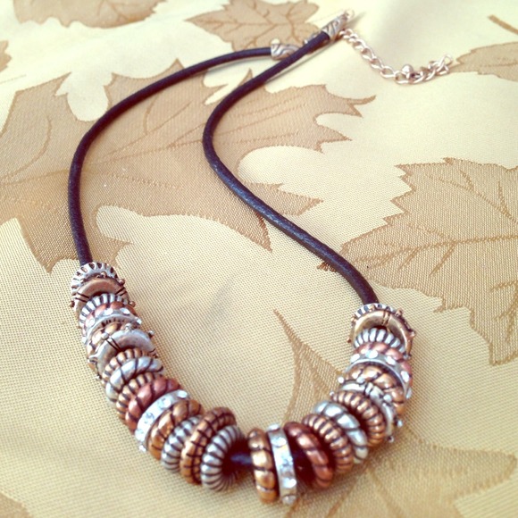 Bronze, gold, and silver ring necklace