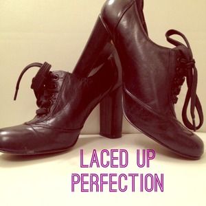 Laced up heeled black leather oxfords