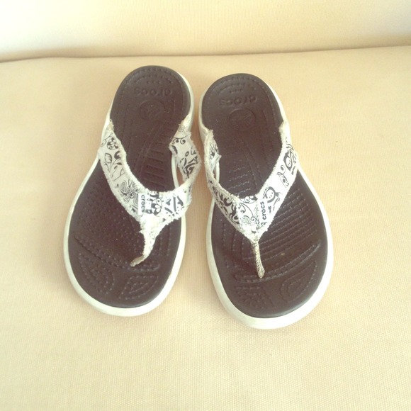Crocs black and white sandals/flip flops.