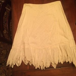 White skirt with arrow pointed hemline.