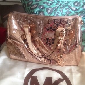 Large Michael Kors rose gold satchel.