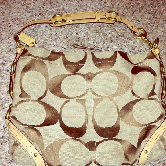 Coach purse with leather tab straps