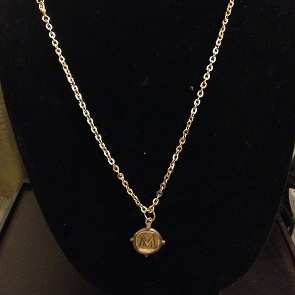 M pendant on brass cord