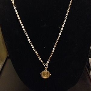 M pendant on brass cord