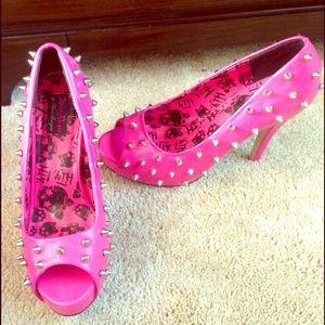 Hot pink spiked pumps