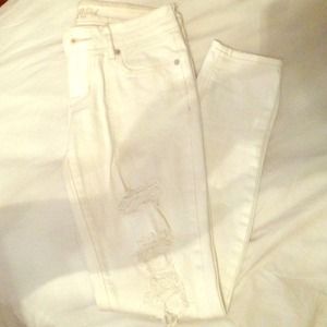 Distressed white skinny jeans