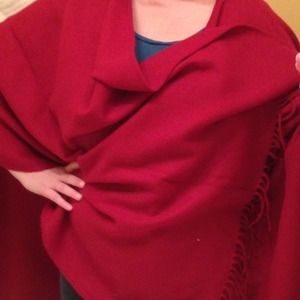 Red shawl wrap with fringes.