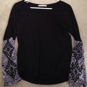 Black shirt with decorative sleeves.