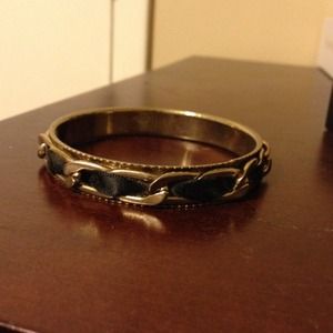 Gold bracelet with black ribbon