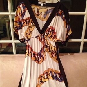 Gorgeous silk like v neck dress with chain design.