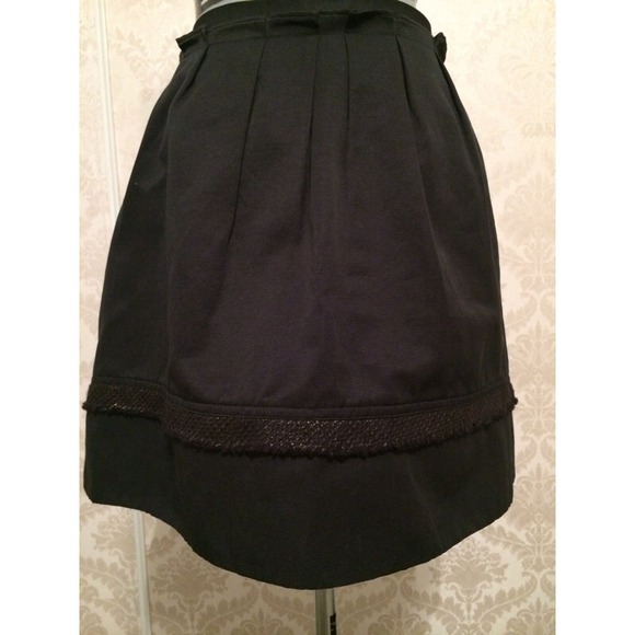 Black skirt with gold accent around the bottom.