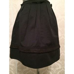 Black skirt with gold accent around the bottom.
