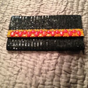 A black sparkly completely hand embroided clutch.