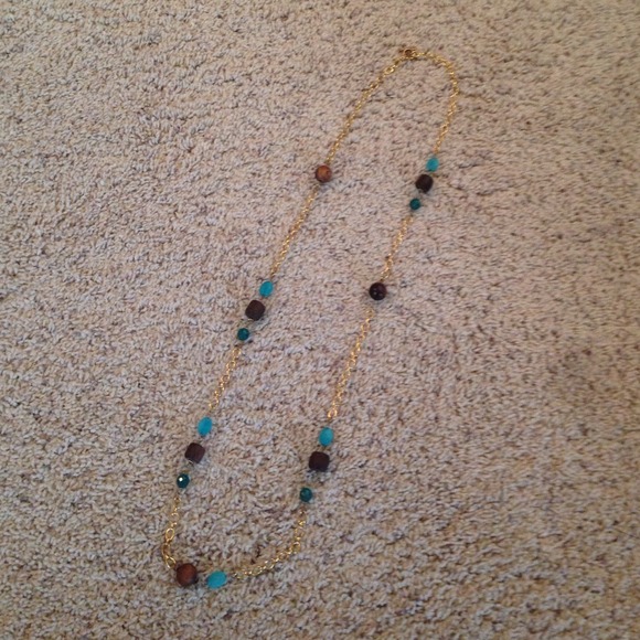 Gold LOFT necklace with brown and teal beads.