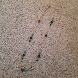 Gold LOFT necklace with brown and teal beads.
