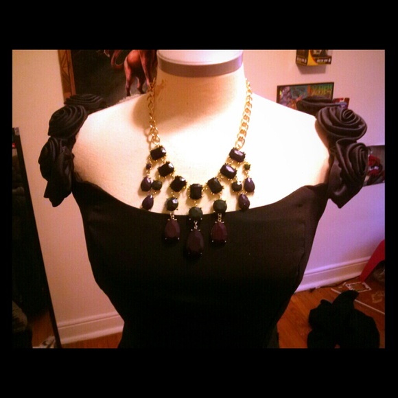 Black floor length boat neck dress.