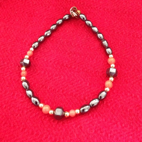 Bracelet, gray with a touch of orange.