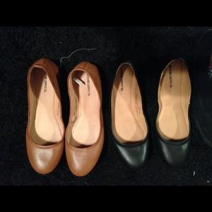 Black and light brown pair of flats come together