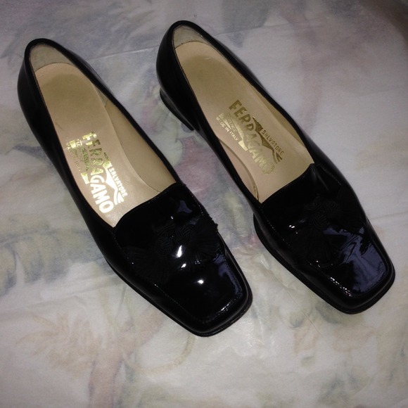 Black patten Ferragamo tassel shoes.